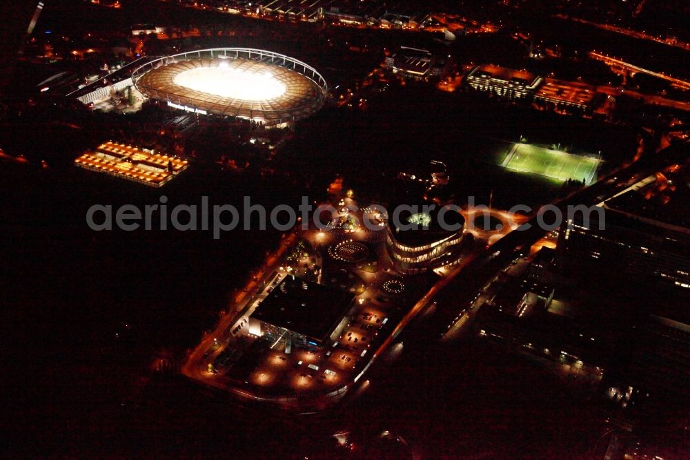 Stuttgart at night from the bird perspective: Night Aerial view of the Mercedes Benz Arena stadium and the Mercedes Benz Museum in Stuttgart in Baden-Wuerttemberg