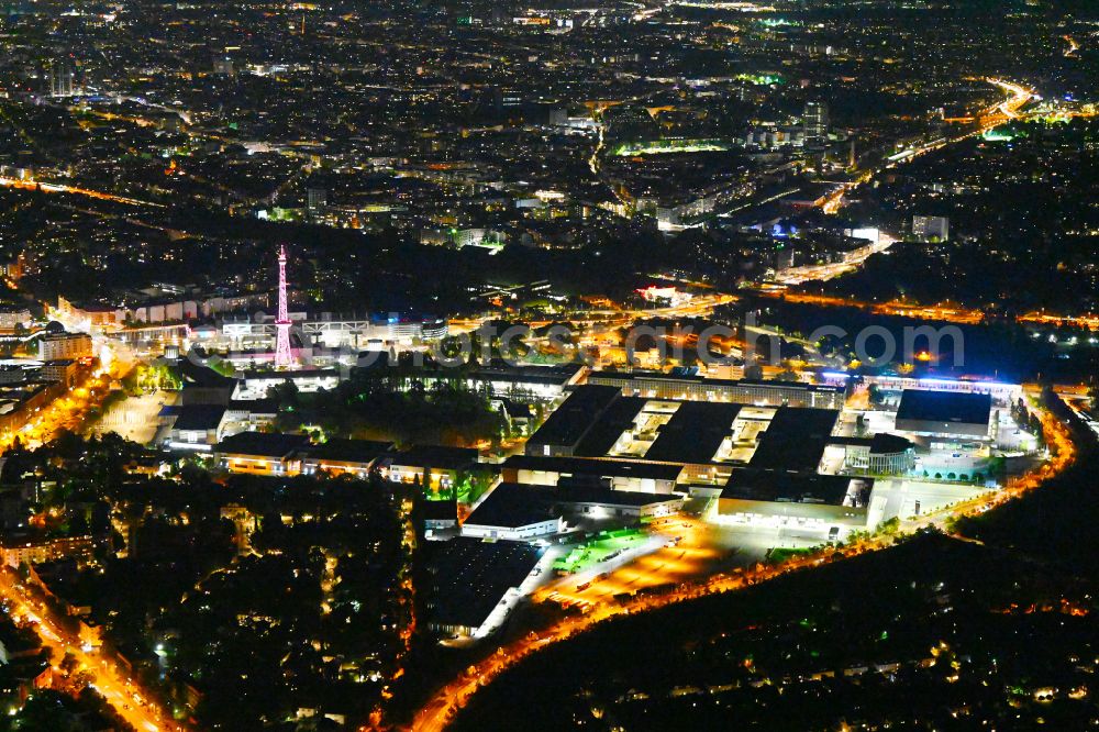 Aerial photograph at night Berlin - Night lighting exhibition grounds and exhibition halls on Funkturm - Messedamm - Kongresszentrum ICC and the highway and motorway crosssing A100 to A115 in the district Charlottenburg in Berlin, Germany