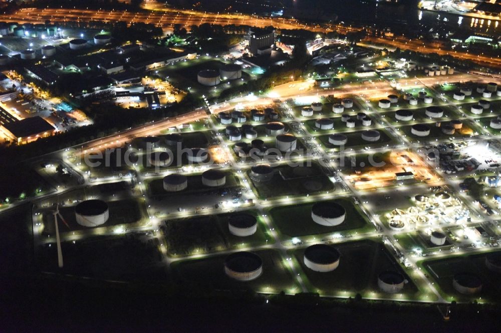 Hamburg at night from above - Mineral oil - tank illuminated at night in the port area on the banks of the Elbe in Hamburg