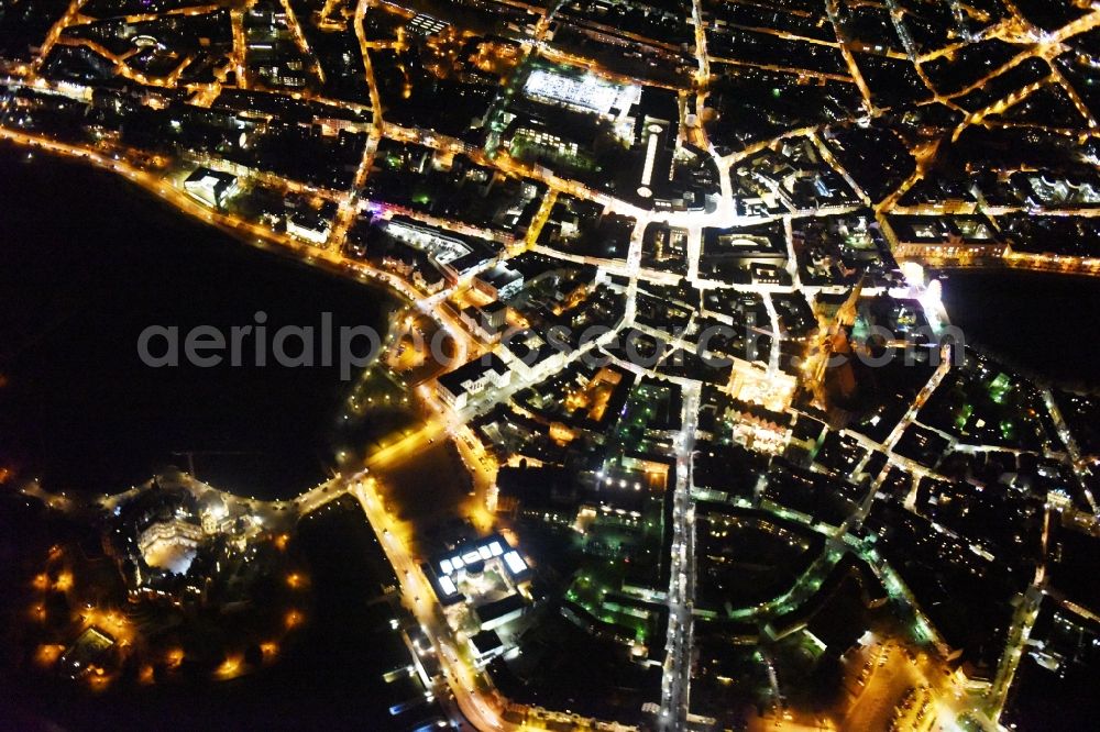 Aerial image at night Schwerin - Night view of the downtown area of Schwerin in the state Mecklenburg - Western Pomerania. In the picture as well the castle schwerin at the Burgsee