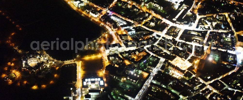 Aerial image at night Schwerin - Night view of the downtown area of Schwerin in the state Mecklenburg - Western Pomerania. In the picture as well the castle schwerin at the Burgsee