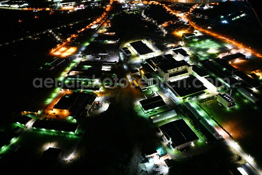 Waltershausen at night from the bird perspective: Night lighting buildings and production halls on the vehicle construction of Multicar site in Waltershausen in the state Thuringia, Germany