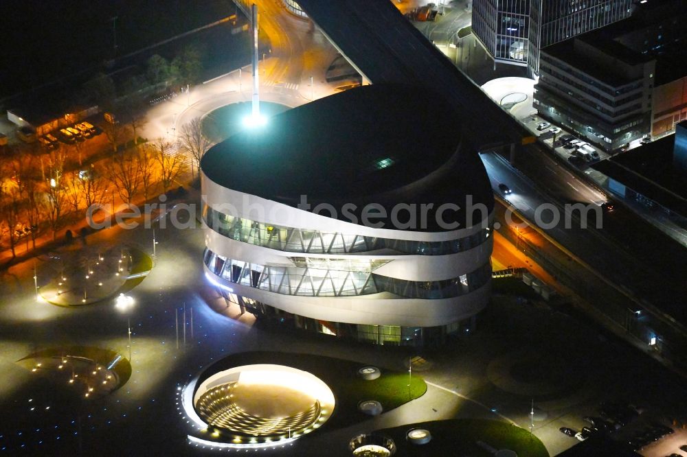 Aerial image at night Stuttgart - Night lighting museum building ensemble Mercedes-Benz Museum on Mercedesstrasse in the district Untertuerkheim in Stuttgart in the state Baden-Wurttemberg, Germany