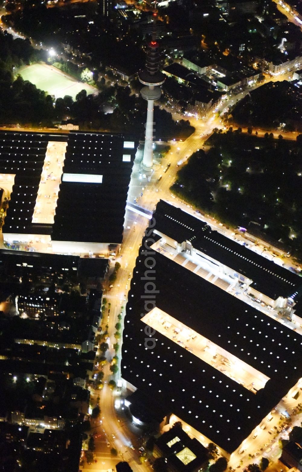 Aerial image at night Hamburg - Night view of tv- tower on Exhibition grounds and exhibition halls of the Hamburg Messe und Congress GmbH in Hamburg