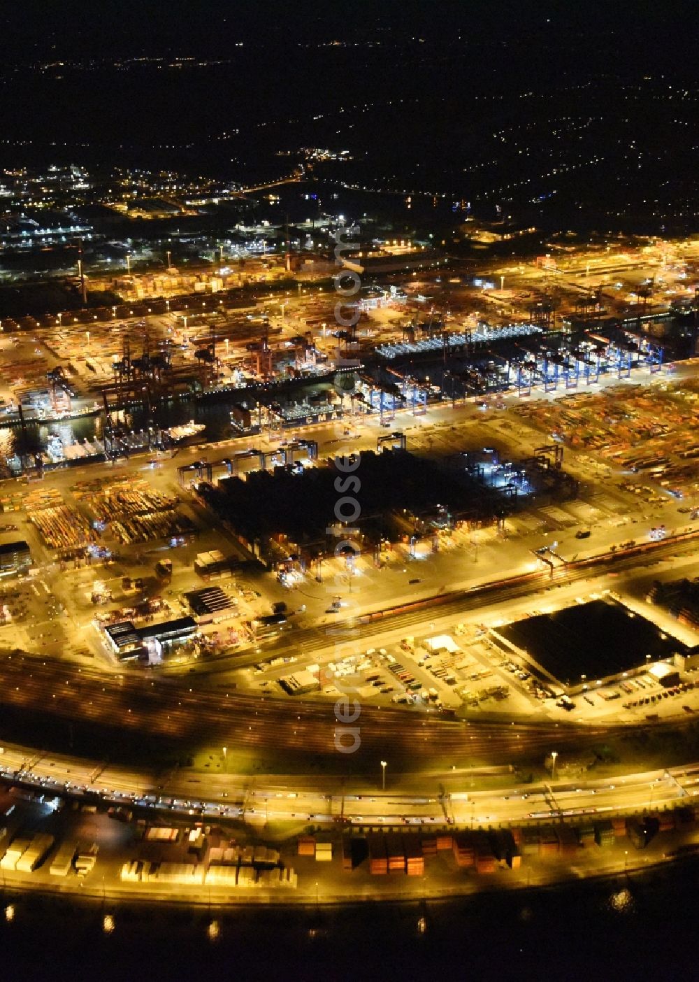 Aerial photograph at night Hamburg - Night view of Container Terminal in the port of the international port of HHLA Logistics Container Terminal Eurogate in Hamburg