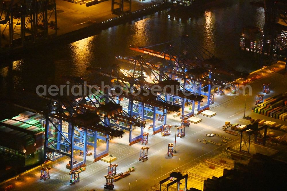 Hamburg at night from the bird perspective: Night view of Container Terminal in the port of the international port of HHLA Logistics Container Terminal Eurogate in Hamburg