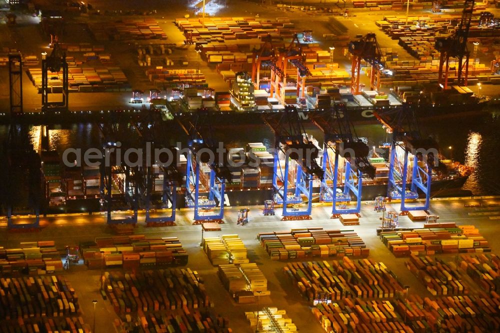 Hamburg at night from the bird perspective: Night view of Container Terminal in the port of the international port of HHLA Logistics Container Terminal Eurogate in Hamburg