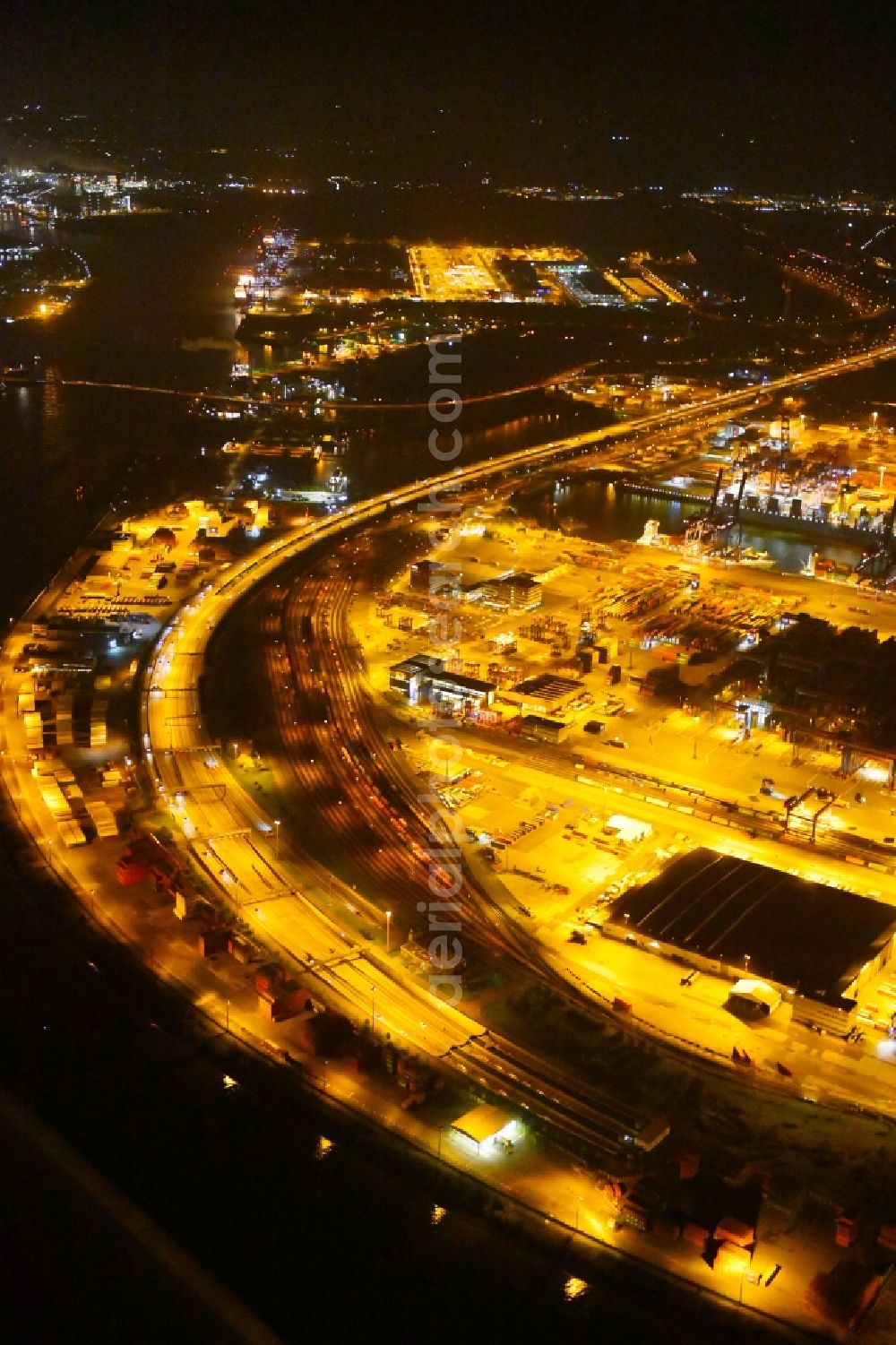 Hamburg at night from the bird perspective: Night view of Container Terminal in the port of the international port of HHLA Logistics Container Terminal Eurogate in Hamburg