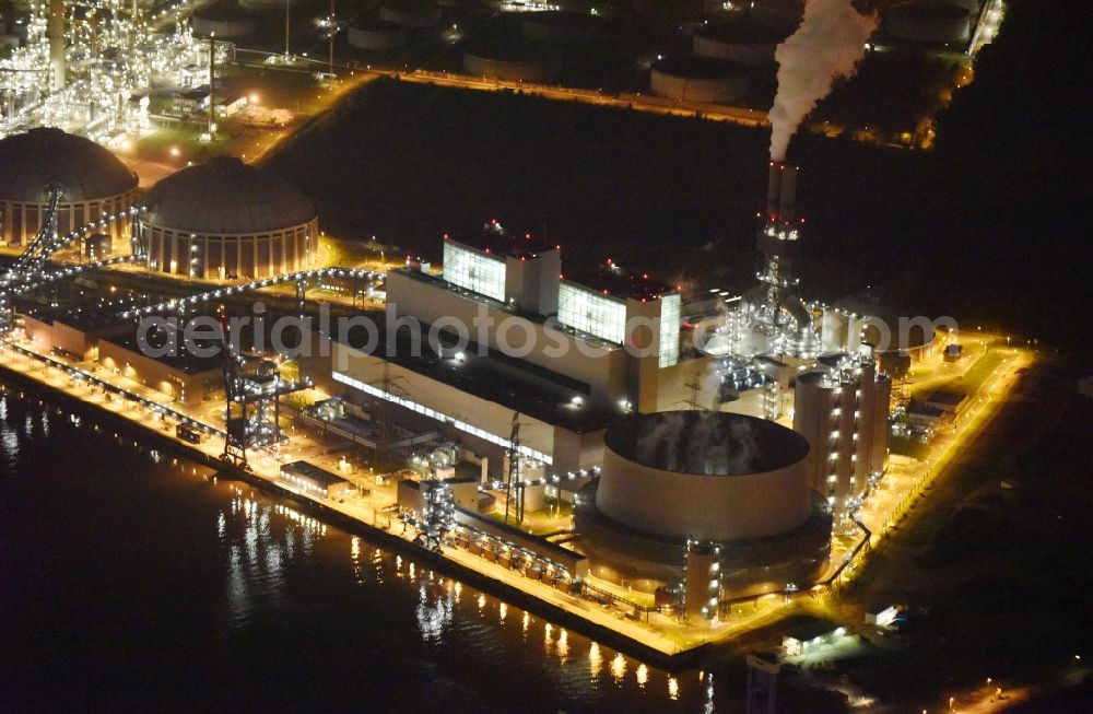 Hamburg at night from above - Night view Coal power plants of the Vattenfall power plant Moorburg in Hamburg in Germany. The power plant with its domes, silos and technical facilities is located on the riverbank of the Suederelbe