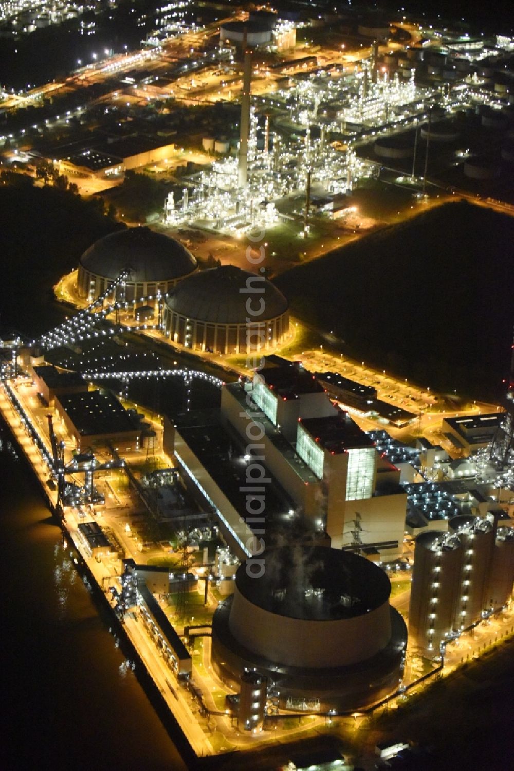 Aerial image at night Hamburg - Night view Coal power plants of the Vattenfall power plant Moorburg in Hamburg in Germany. The power plant with its domes, silos and technical facilities is located on the riverbank of the Suederelbe