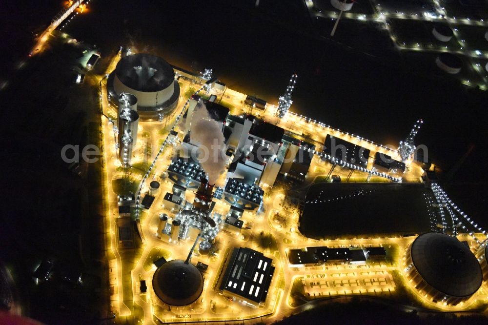 Aerial image at night Hamburg - Night view Coal power plants of the Vattenfall power plant Moorburg in Hamburg in Germany. The power plant with its domes, silos and technical facilities is located on the riverbank of the Suederelbe