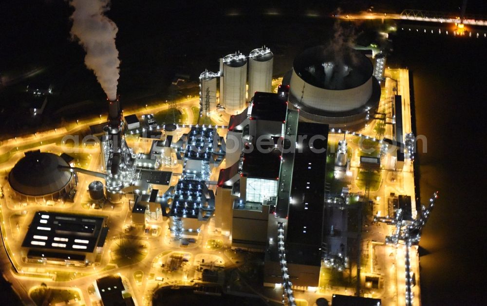 Hamburg at night from above - Night view Coal power plants of the Vattenfall power plant Moorburg in Hamburg in Germany. The power plant with its domes, silos and technical facilities is located on the riverbank of the Suederelbe