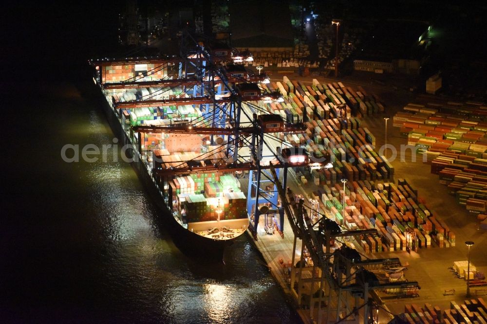 Hamburg at night from the bird perspective: Night view Container ship Trollerort - Steinwerder shore of Norderelbe port aerea in Hamburg