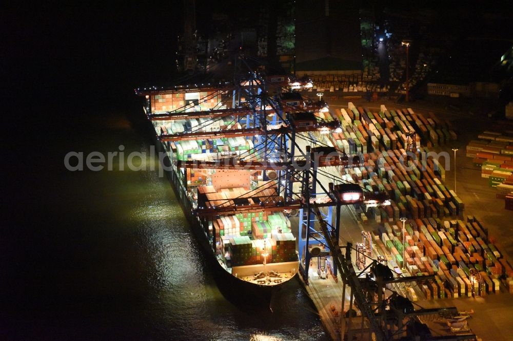 Aerial image at night Hamburg - Night view Container ship Trollerort - Steinwerder shore of Norderelbe port aerea in Hamburg