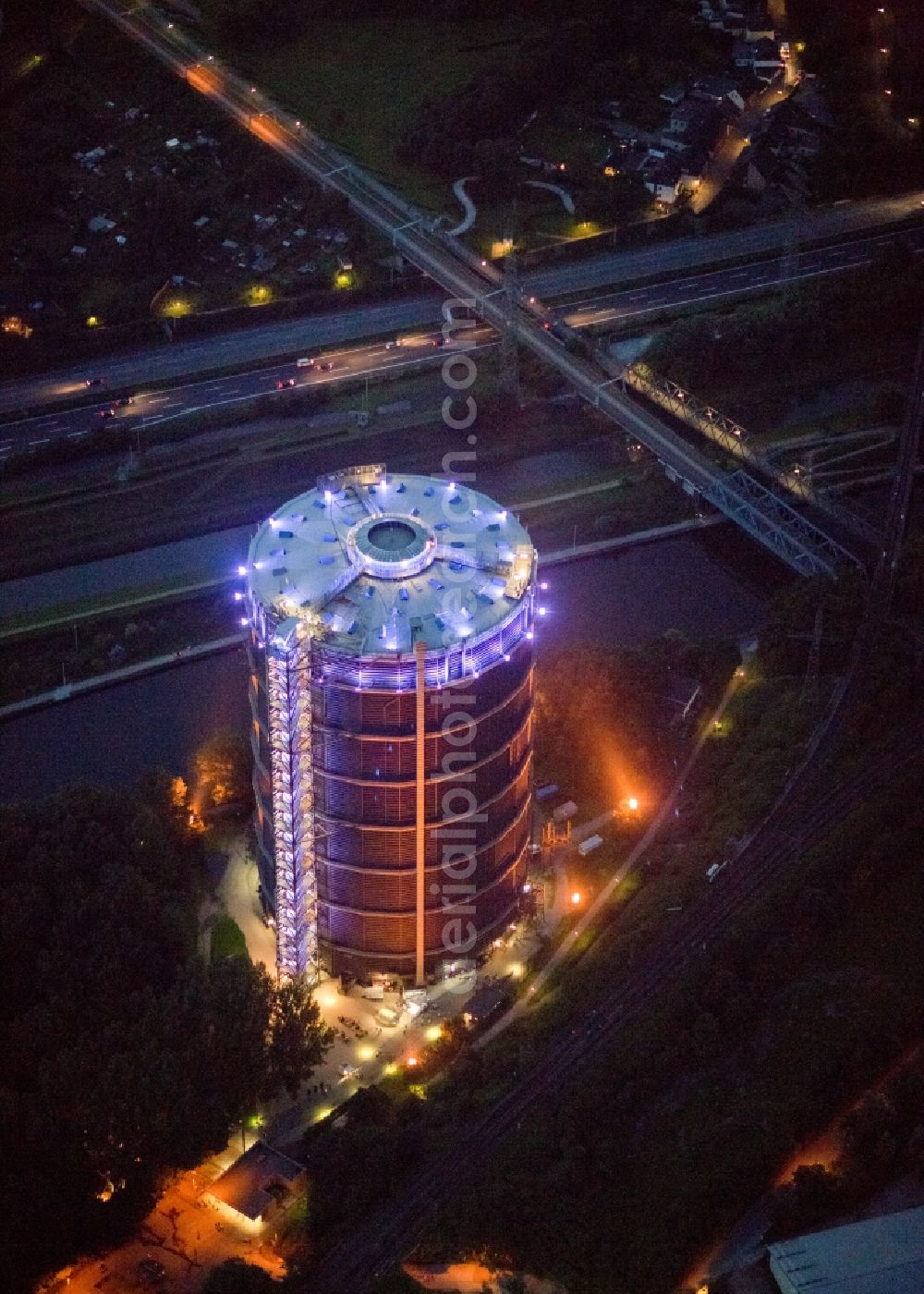 Aerial image at night Oberhausen - Night-time air picture from the Gasometer Oberhausen in Action extra layer 2012th The gasometer is the symbol of the city of Oberhausen, impressive document the construction and history of technology and venue