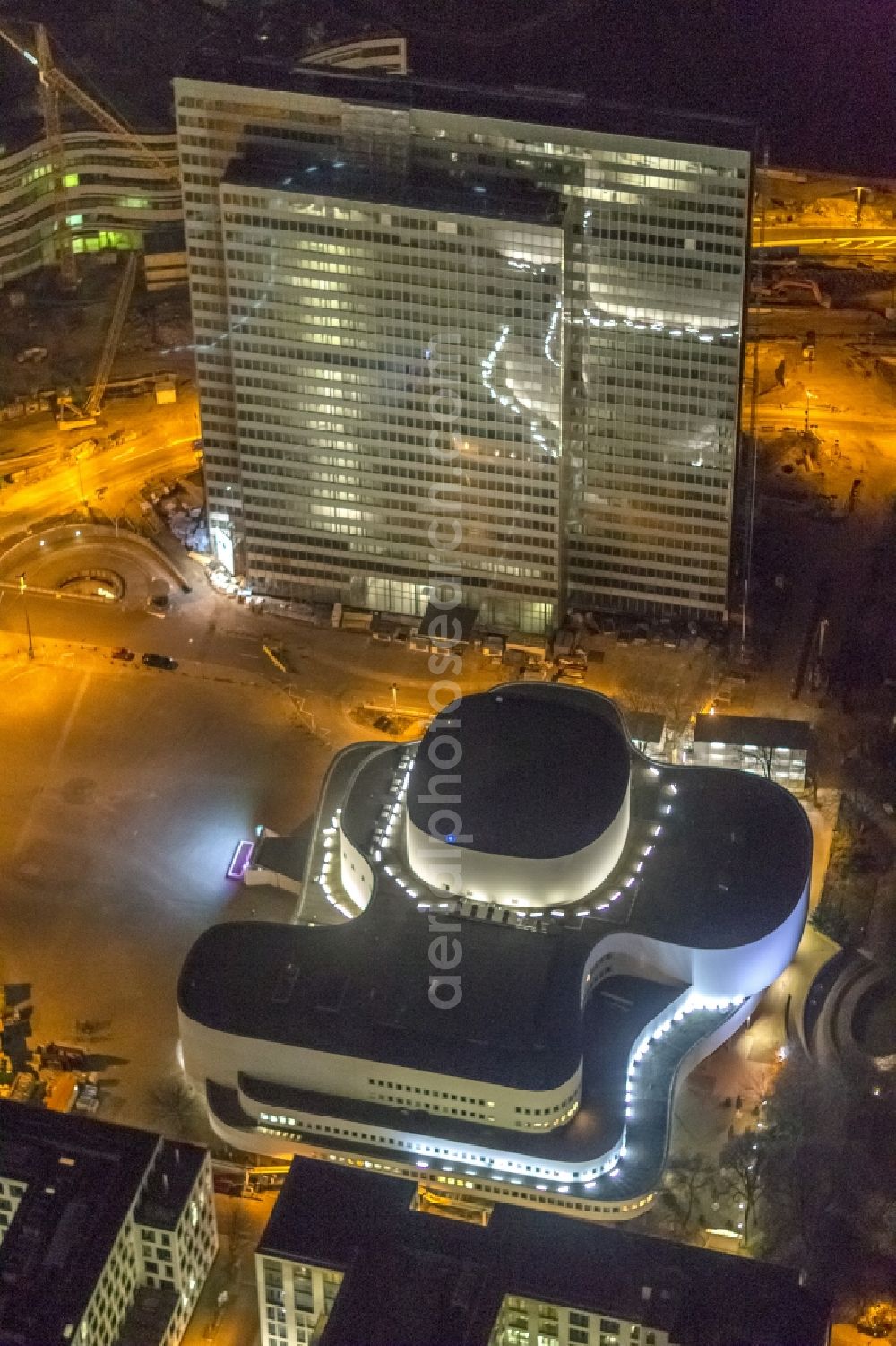 Düsseldorf at night from the bird perspective: Night aerial view of the building of the theater and of the high-rise Dreischeibenhaus in downtown Dusseldorf in North Rhine-Westphalia