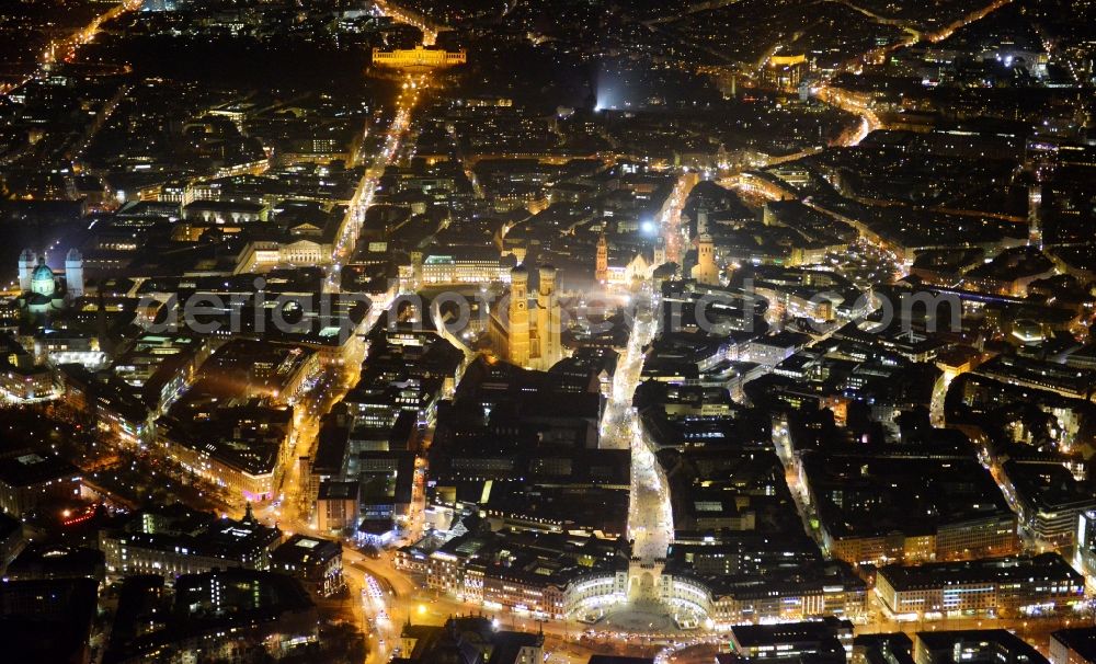 München at night from the bird perspective: City view of the Old Town at the Frauenkirche at the New Town Hall and place Karlsplatz in the center of Munich in Bavaria