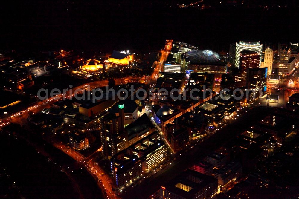 Berlin at night from the bird perspective: Night view of Complex with its high-rise building Sony Center - Bahntower at Potsdamer Platz