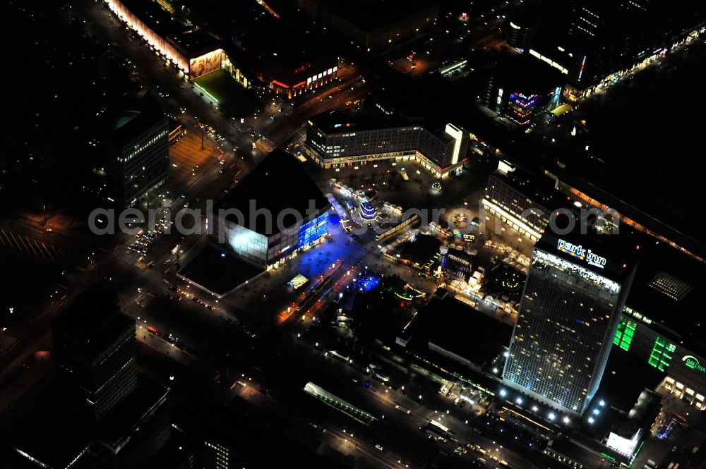 Aerial photograph at night Berlin - Nightview of the Oktoberfest at Alexanderplatz in the district Mitte in Berlin. Located betweenn ALEXA und Saturn it consists of several booths with Bavarian specialties and a marquee. Promoter is the federal state of Bavaria