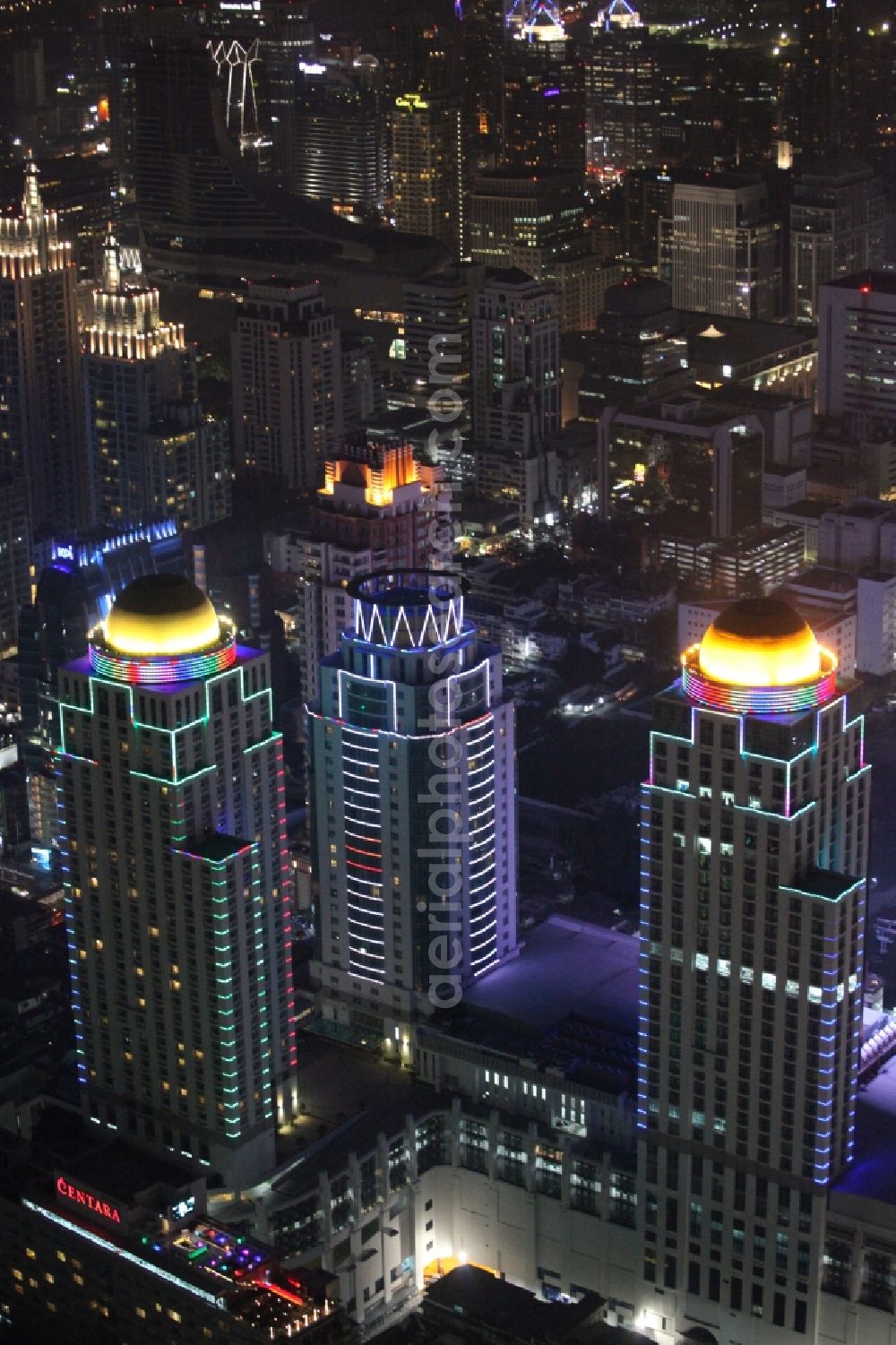 Aerial photograph at night Bangkok - Night view of the illuminated roof domes of high-rise towers of Pratunam Shopping Center in the center of the city of Bangkok in Thailand