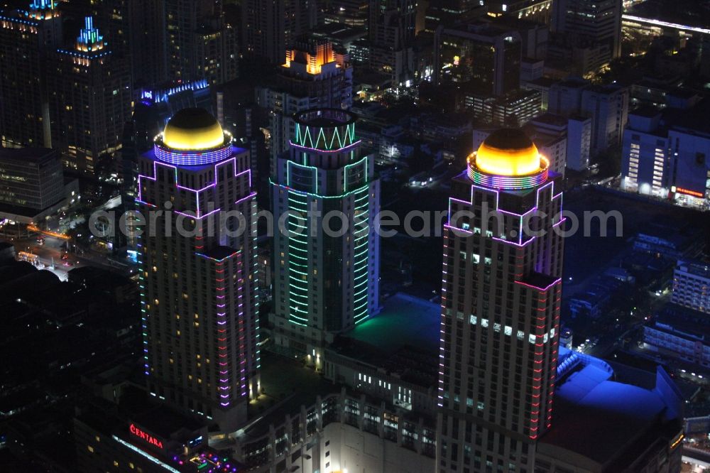 Aerial image at night Bangkok - Night view of the illuminated roof domes of high-rise towers of Pratunam Shopping Center in the center of the city of Bangkok in Thailand