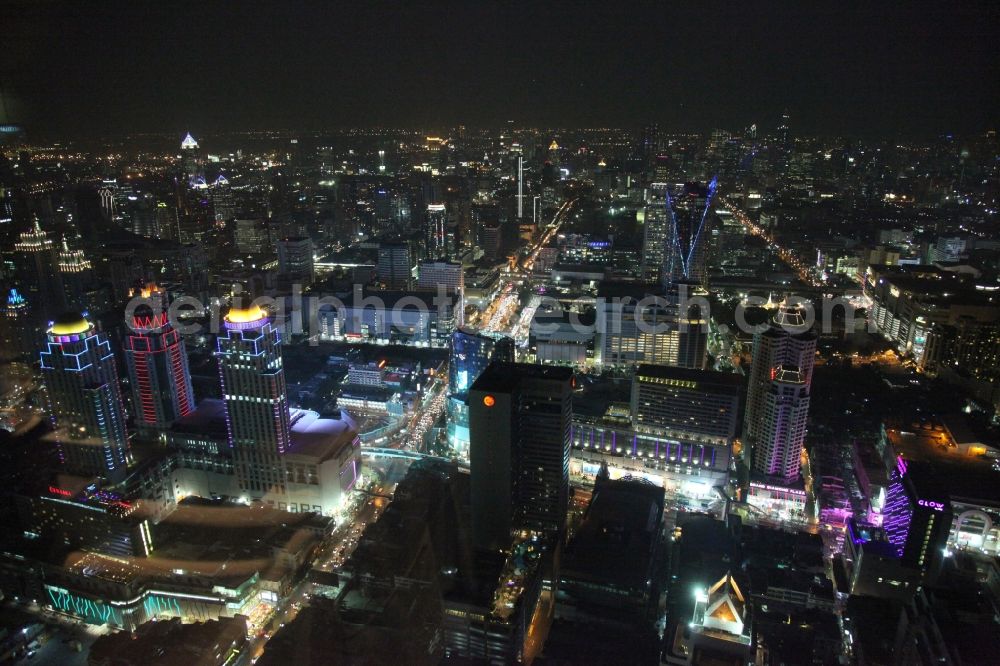 Bangkok at night from the bird perspective: Night view of the illuminated roof domes of high-rise towers of Pratunam Shopping Center in the center of the city of Bangkok in Thailand