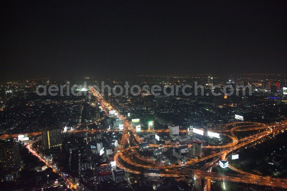 Bangkok at night from above - Night view of the illuminated city highway guide at the center of Bangkok in Thailand