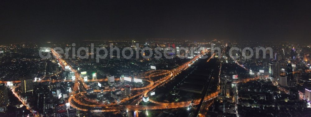 Bangkok at night from the bird perspective: Night view of the illuminated city highway guide at the center of Bangkok in Thailand
