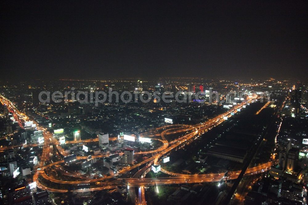 Aerial image at night Bangkok - Night view of the illuminated city highway guide at the center of Bangkok in Thailand