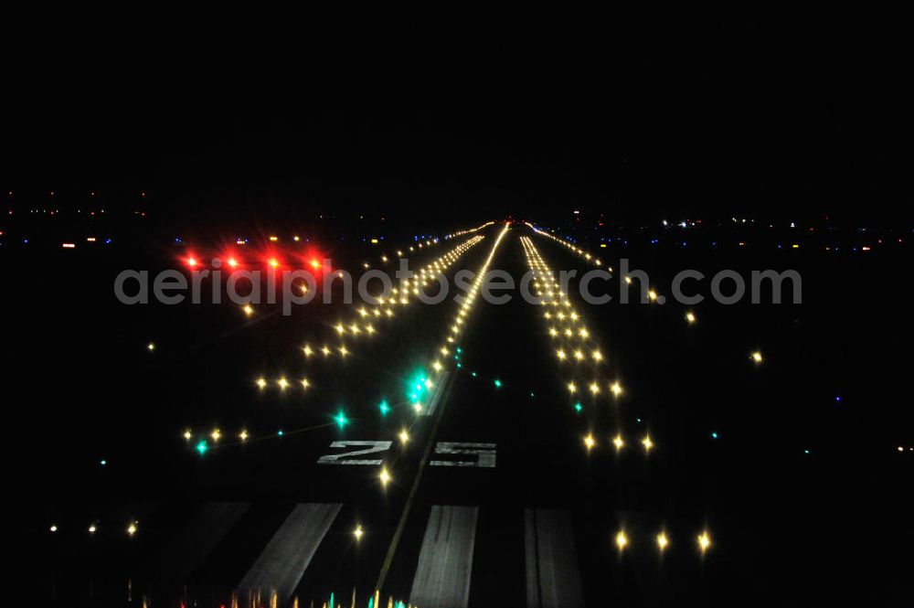 Aerial image at night Schönefeld - Nachtaufnahme: Beleuchtung / Befeuerung der Landebahn / Startbahn am Flughafen Schönefeld EDDB. Night Shot: Lighting / beaconing of the runway at the Berlin-Schoenefeld airport SXF.