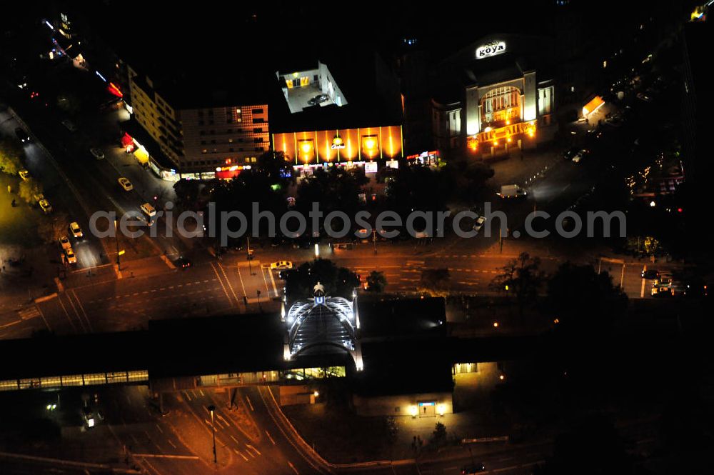 Berlin at night from the bird perspective: Nachtaufnahme: Nollendorfplatz in Berlin-Schöneberg mit dem Hochbahnhof der U-Bahn-Linie 2. Hier treffen sich die Einemstraße, die Maaßenstraße, die Kleiststraße und die Bülowstraße. Zu sehen auch das Gebäude der Ü-30-Party der media.one GmbH. Night shot: The square Nollendorfplatz with the station of the overhead railway.