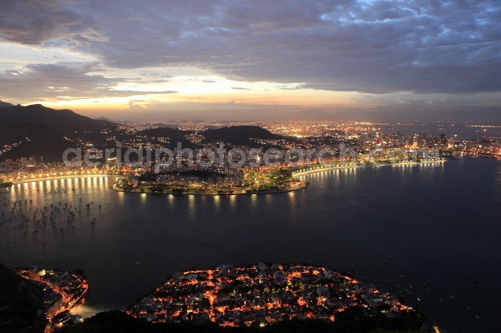 Rio de Janeiro at night from the bird perspective: Beach and coastal area on the outskirts of Ipanema in Rio de Janeiro in Brazil