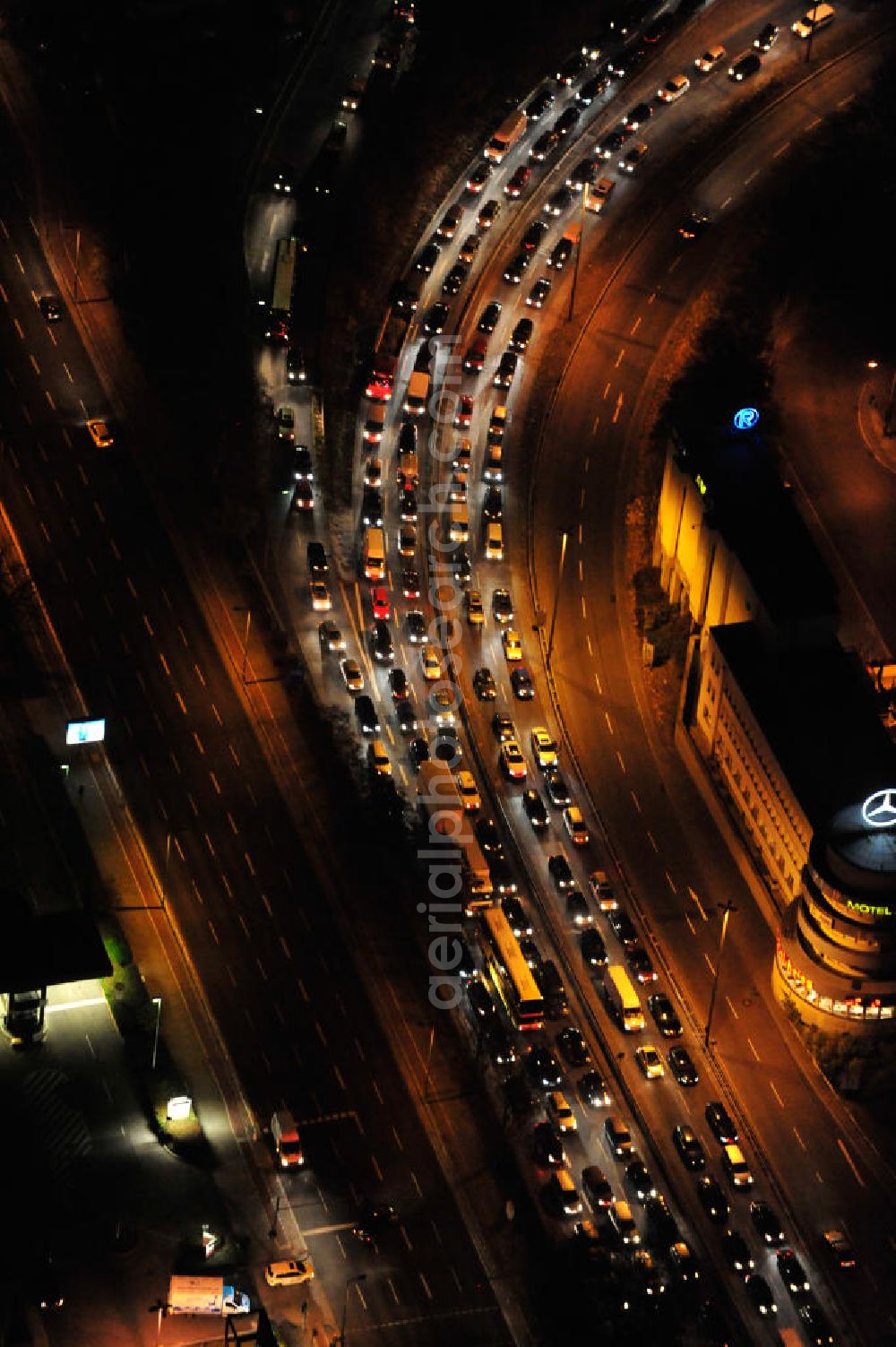 Berlin at night from the bird perspective: Nachtaufnahme eines Stau auf der Avus / Autobahn A 115 in Berlin Charlottenburg. Night shot of the Avus / highway / motorway in Berlin Charlottenburg.