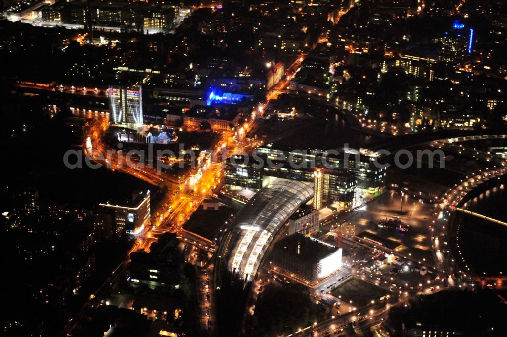 Berlin at night from the bird perspective: Night view at the central station in the district Tiergarten in Berlin. The central station is the largest station tower in Europe and the main railway hub of Berlin