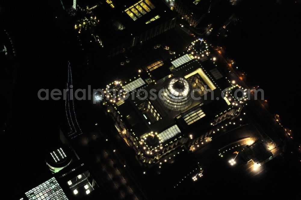 Aerial photograph at night Berlin - Night view at the Reichstag in the district Mitte in Berlin. The Reichstag is the domicile of the german federal parliament