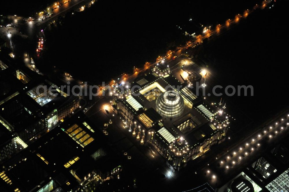 Berlin at night from above - Night view at the Reichstag in the district Mitte in Berlin. The Reichstag is the domicile of the german federal parliament