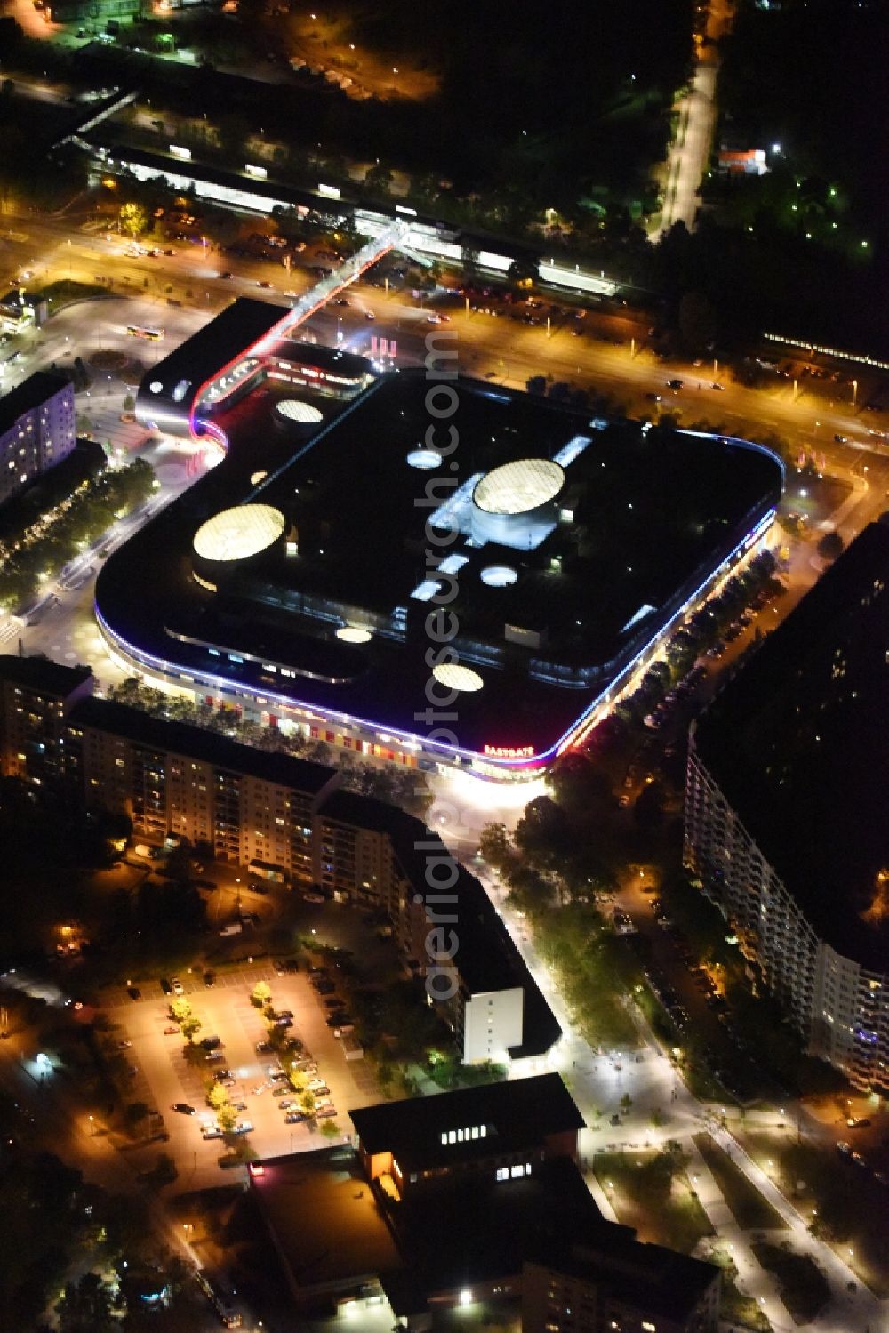 Berlin at night from the bird perspective: Night Aerial View of Shopping Center East Gate with coherent nocturnal lighting. The development, general planning, leasing and long-term management of the Eastgate project management are in the hands of the ECE. The shopping center is located in the Marzahn district on the main road axis Maerkische Allee in Berlin