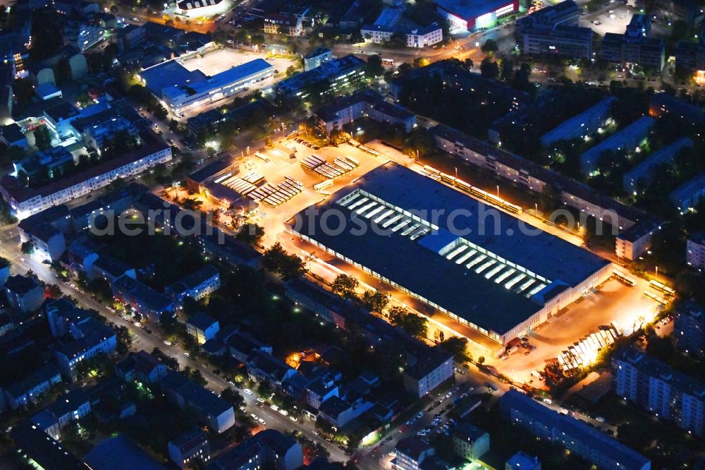 Berlin at night from the bird perspective: Night lighting depot of the Municipal Transport Company Am Strassenbahnhof - Gradestrasse in the district Britz in Berlin, Germany