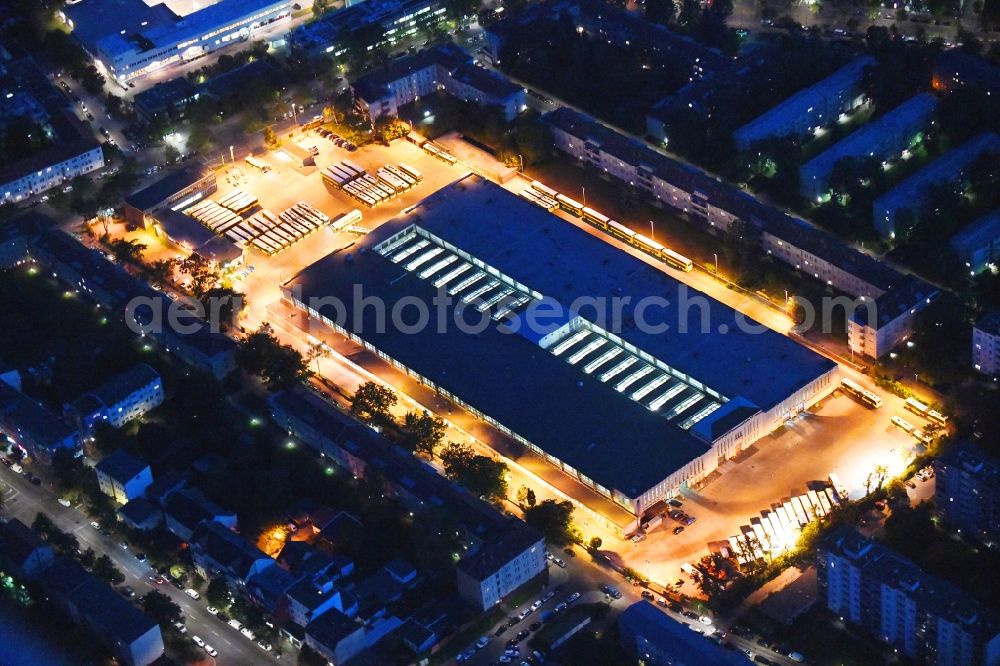 Aerial photograph at night Berlin - Night lighting depot of the Municipal Transport Company Am Strassenbahnhof - Gradestrasse in the district Britz in Berlin, Germany