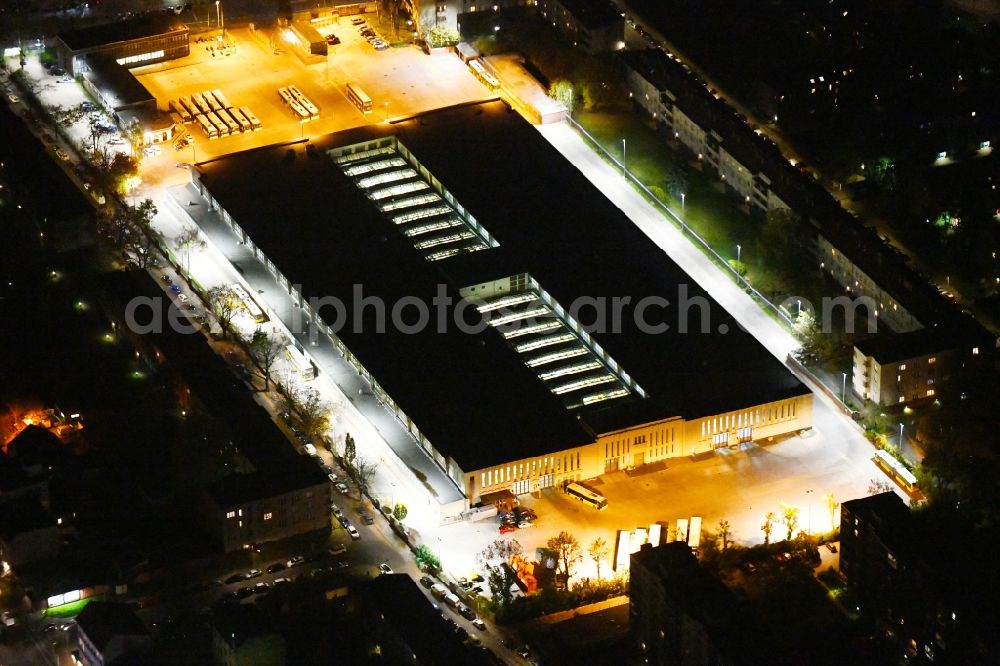 Aerial photograph at night Berlin - Night lighting depot of the Municipal Transport Company Am Strassenbahnhof - Gradestrasse in the district Britz in Berlin, Germany