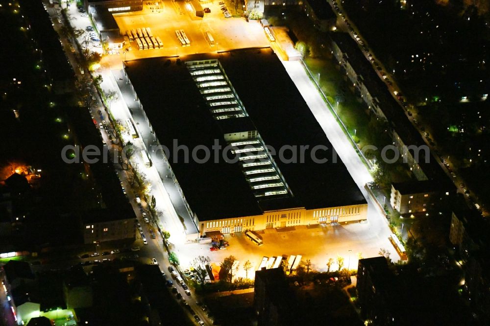 Berlin at night from the bird perspective: Night lighting depot of the Municipal Transport Company Am Strassenbahnhof - Gradestrasse in the district Britz in Berlin, Germany