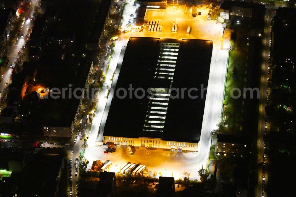 Aerial photograph at night Berlin - Night lighting depot of the Municipal Transport Company Am Strassenbahnhof - Gradestrasse in the district Britz in Berlin, Germany