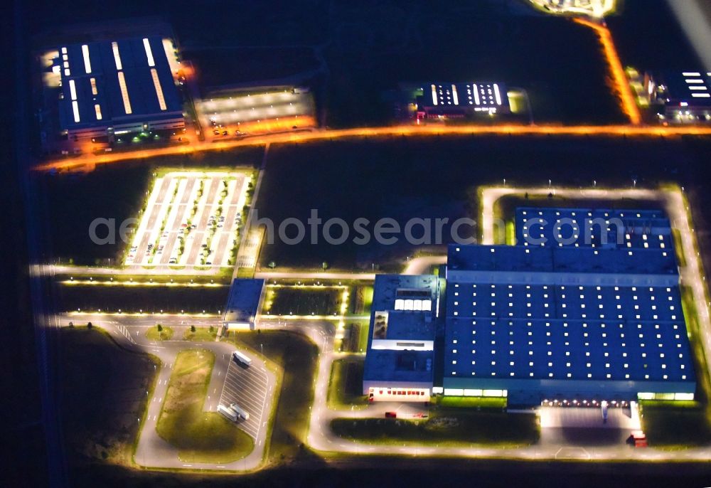 Aerial image at night Schwerin - Night lighting Nestle - manufacturing plant in the Industrial Park Schwerin in Mecklenburg - Western Pomerania