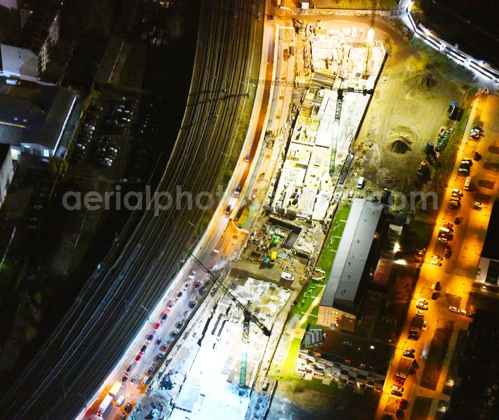 Aerial image at night Berlin - Night lighting Construction site to build a new office and commercial building B:HUB on Kynaststrasse - Alt-Stralau in Berlin, Germany