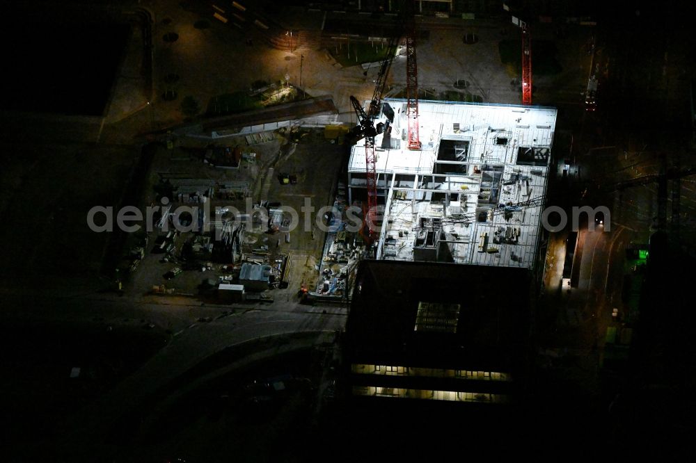 Aerial photograph at night Hamburg - Night lighting construction site to build a new office and commercial building EDGE ElbSide on place Amerigo-Vespucci-Platz in the district HafenCity in Hamburg, Germany