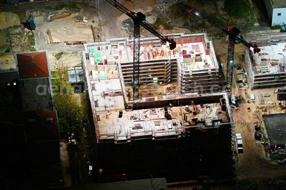 Aerial image at night Berlin - Night lighting construction site to build a new office and commercial building SIEMENSSTADT SQUARE on street Gartenfelder Strasse in the district Siemensstadt in Berlin, Germany