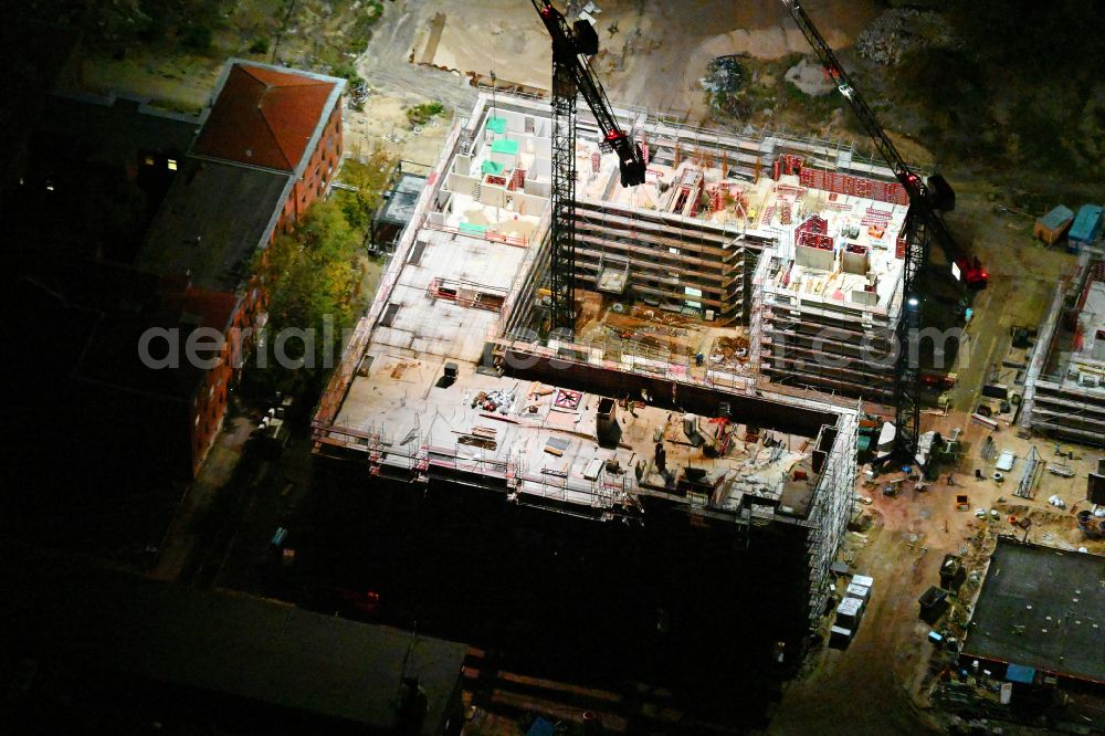 Berlin at night from above - Night lighting construction site to build a new office and commercial building SIEMENSSTADT SQUARE on street Gartenfelder Strasse in the district Siemensstadt in Berlin, Germany