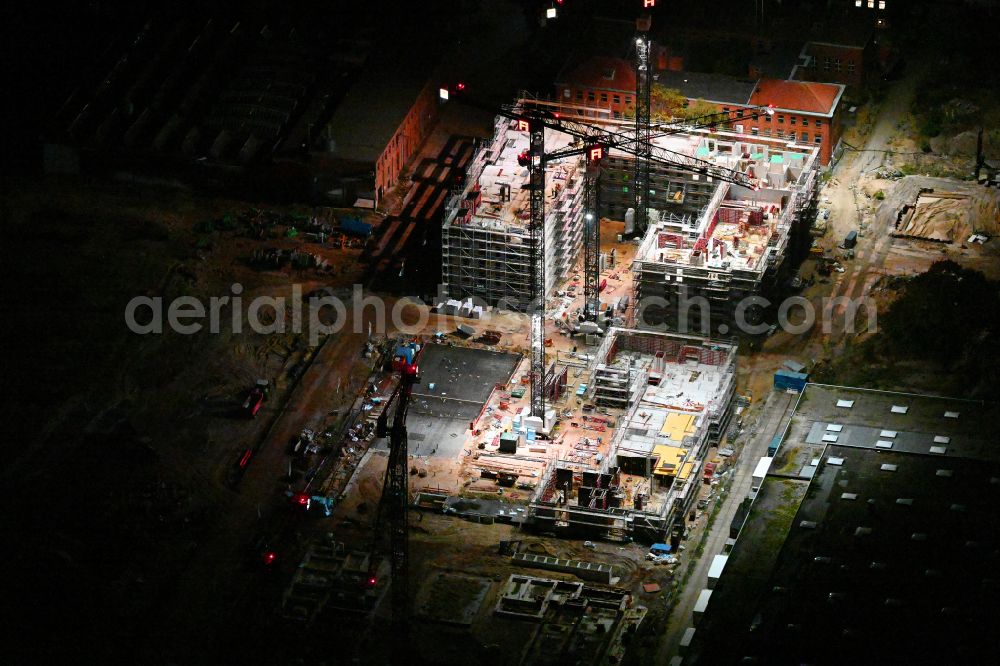 Aerial image at night Berlin - Night lighting construction site to build a new office and commercial building SIEMENSSTADT SQUARE on street Gartenfelder Strasse in the district Siemensstadt in Berlin, Germany