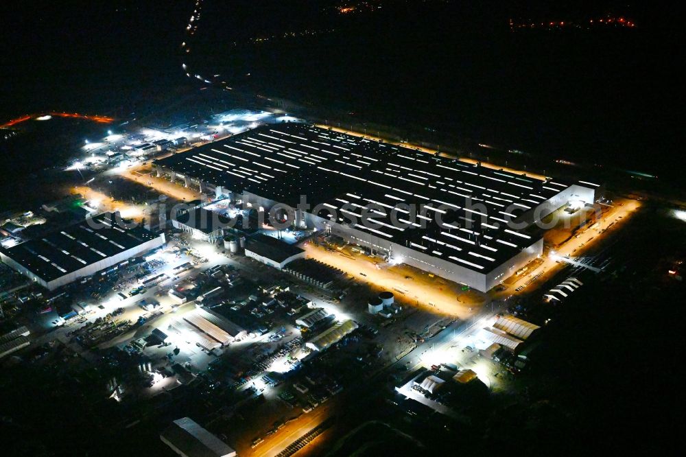 Aerial image at night Grünheide (Mark) - Night lighting construction site for the new building of Tesla Gigafactory 4 on Schlehenweg - Eichenstrasse in the district Freienbrink in Gruenheide (Mark) in the state Brandenburg, Germany