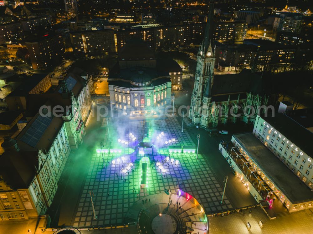 Chemnitz at night from the bird perspective: Night lights and illumination of the Chemnitz Opera House with Theaterplatz on the occasion of the festival Illuminarium - the sound and light festival of film nights and the Petrikirche in Chemnitz in the federal state of Saxony